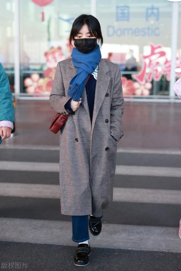 譚松韻穿格紋大衣搭配牛仔褲，系藍色圍巾，腳踩樂福鞋輕鬆隨性