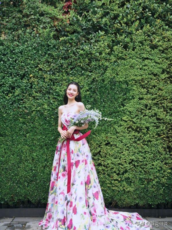 鍾楚曦一襲花瓣抹胸裙，隱藏在花叢中嬌媚動人