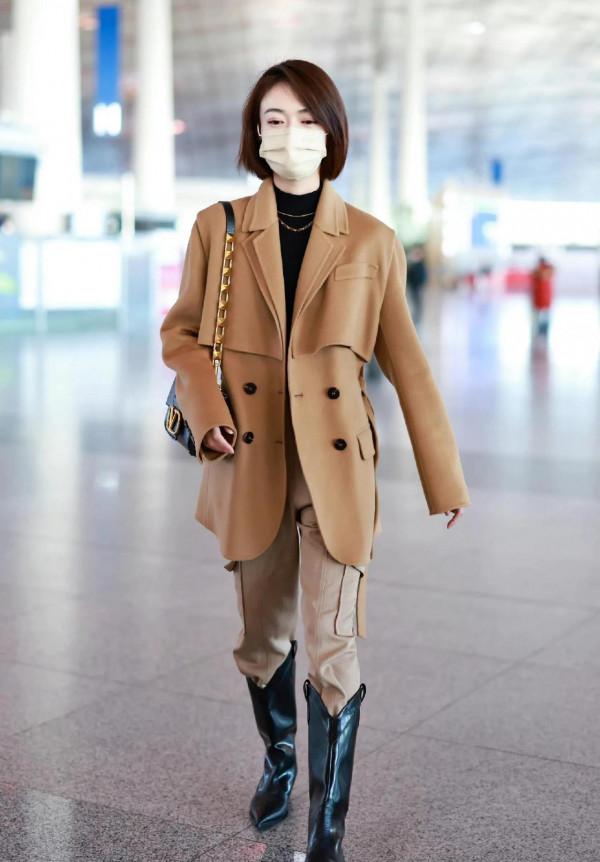 吳謹言私服，身穿呢子大衣腳套大長靴，靴子比包包還要亮