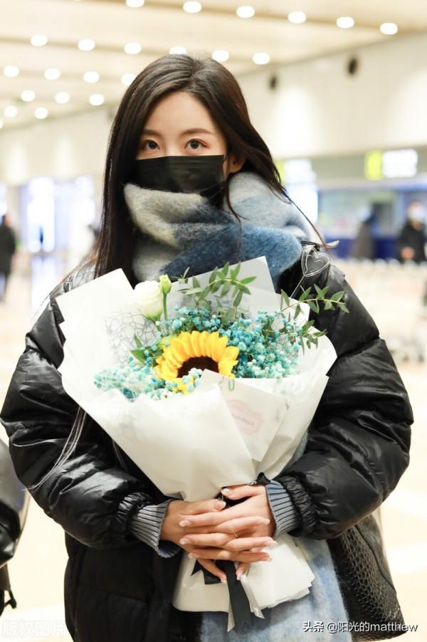 街拍：孫茵身穿黑色羽絨服搭鉛筆褲手捧鮮花人氣旺