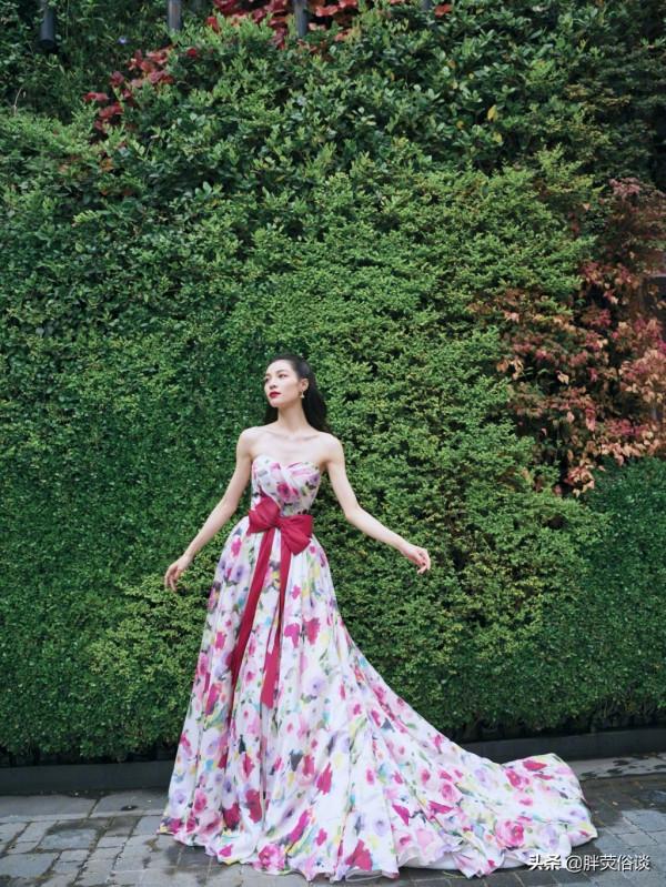 鍾楚曦一襲花瓣抹胸裙，隱藏在花叢中嬌媚動人